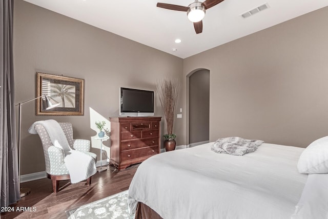 bedroom with ceiling fan and dark hardwood / wood-style flooring