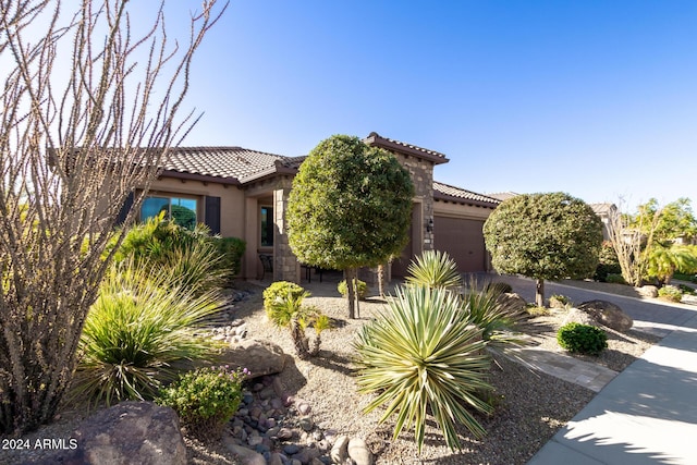 mediterranean / spanish-style home with a garage