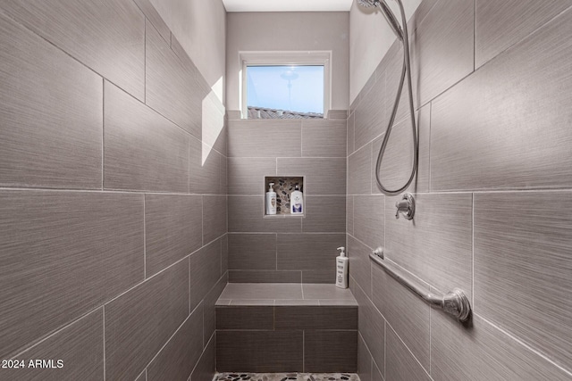 bathroom featuring a tile shower