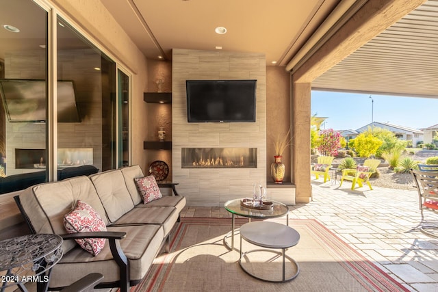 view of patio featuring an outdoor living space with a fireplace