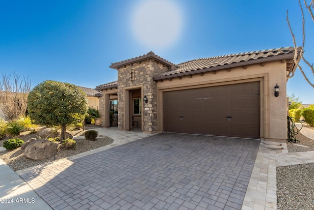 mediterranean / spanish-style house with a garage