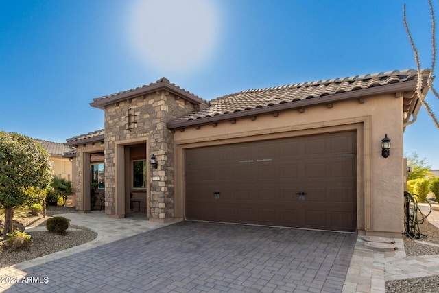 mediterranean / spanish house featuring a garage