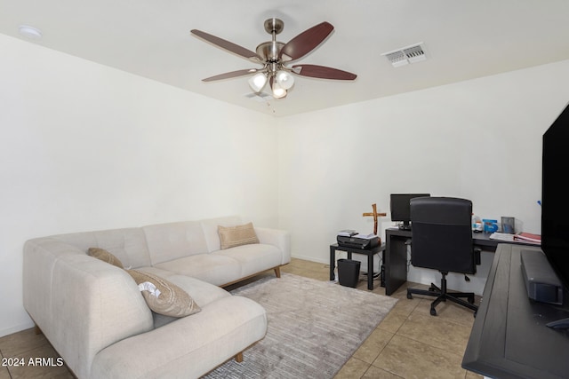 office area with light tile patterned floors, baseboards, visible vents, and a ceiling fan