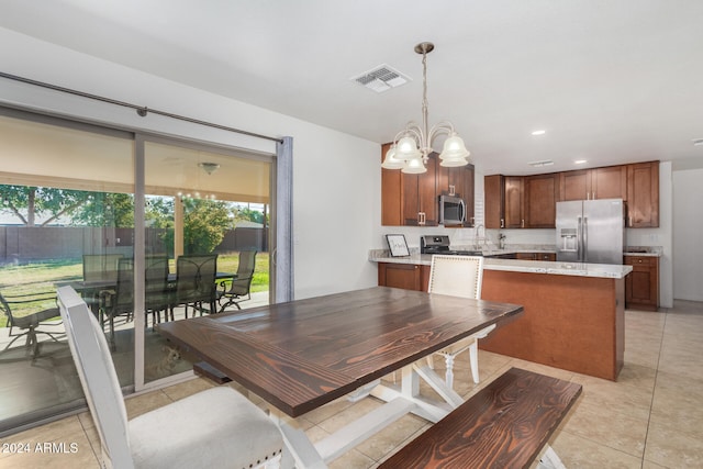 kitchen featuring a chandelier, light tile patterned floors, visible vents, appliances with stainless steel finishes, and decorative light fixtures