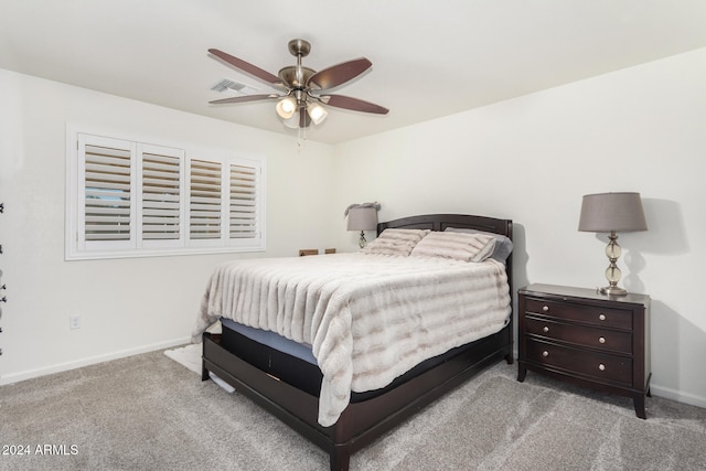 carpeted bedroom featuring ceiling fan, visible vents, and baseboards