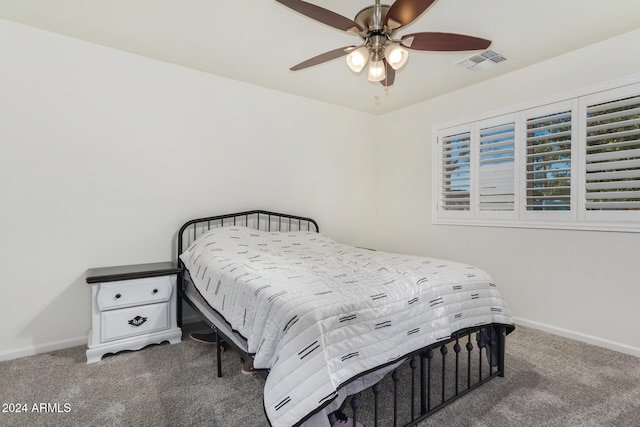 carpeted bedroom featuring ceiling fan, visible vents, and baseboards