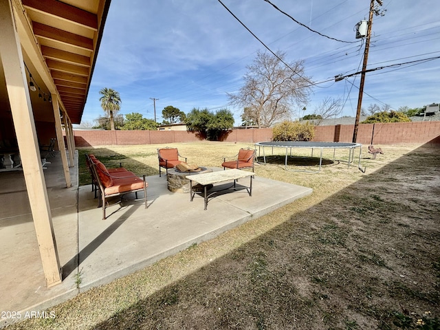 view of yard featuring a fenced backyard, a trampoline, and a patio