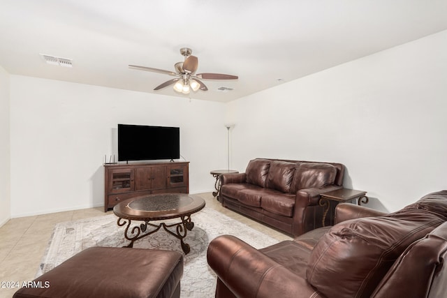 living area with a ceiling fan, visible vents, and baseboards