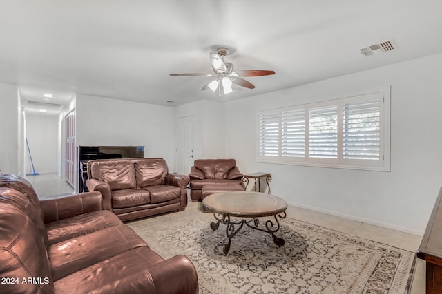 tiled living room with a ceiling fan, visible vents, and baseboards