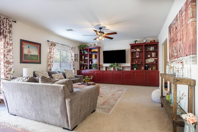 living room featuring light carpet and ceiling fan