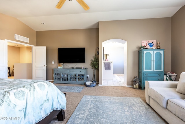 carpeted bedroom featuring ceiling fan and vaulted ceiling