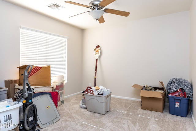 interior space featuring light carpet and ceiling fan