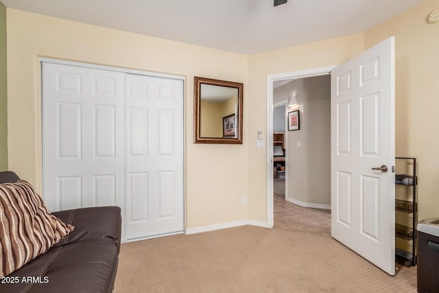 living area with light colored carpet and baseboards