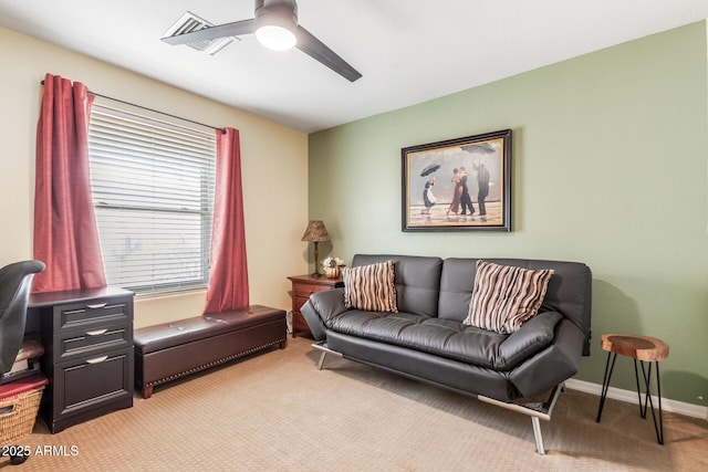 living room featuring light carpet, ceiling fan, visible vents, and baseboards