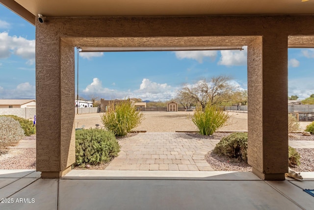 view of patio featuring a residential view and fence