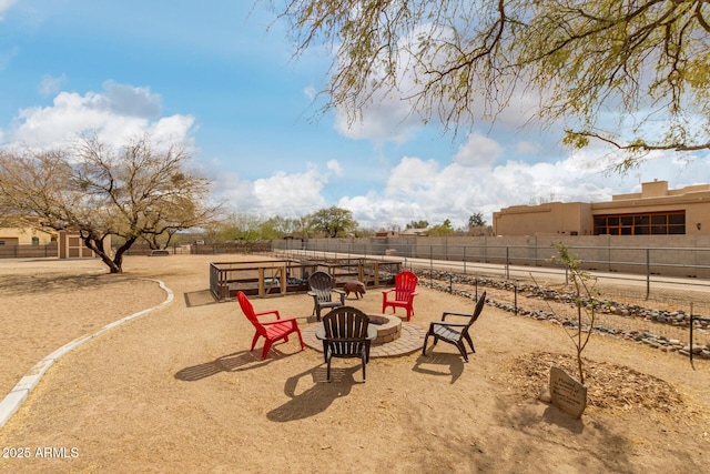 view of yard featuring fence and a fire pit