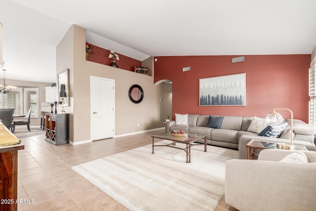 living room with arched walkways, light tile patterned floors, a chandelier, visible vents, and baseboards