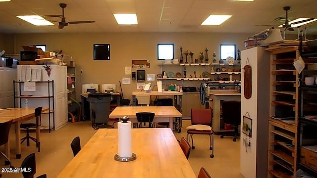 dining room with ceiling fan and a workshop area