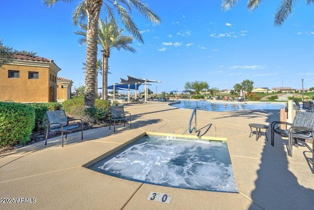 view of pool featuring a patio area and a community hot tub