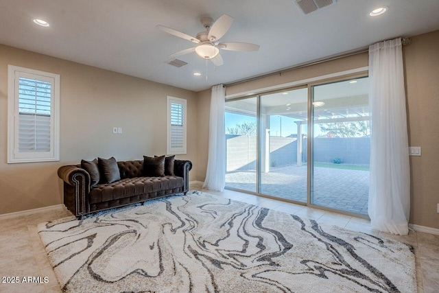 tiled living room featuring ceiling fan and a healthy amount of sunlight