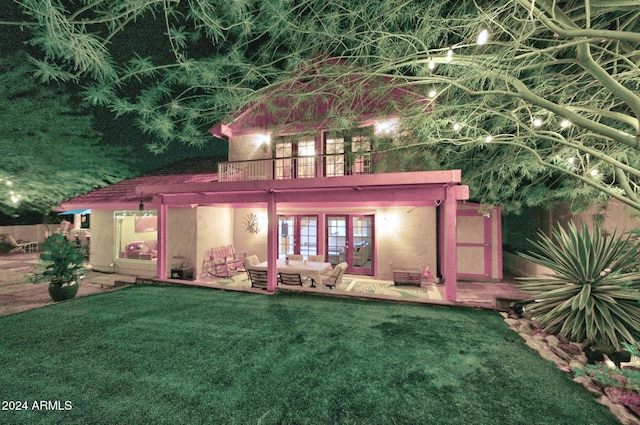 rear view of property featuring a patio area, french doors, and a yard