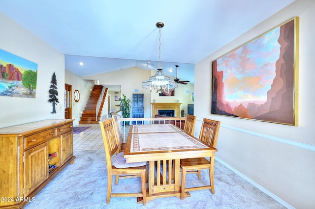 tiled dining room with lofted ceiling and ceiling fan