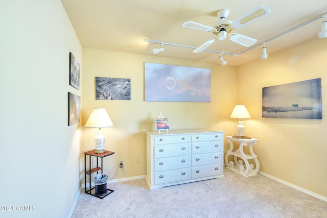 interior space with light carpet, ceiling fan, and rail lighting