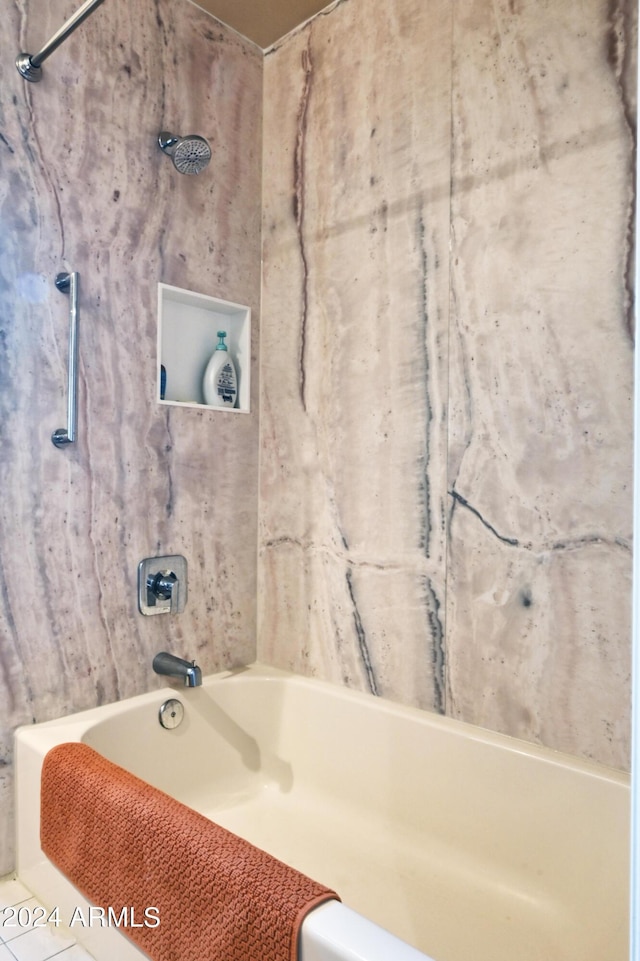 bathroom with tile patterned flooring and shower / washtub combination