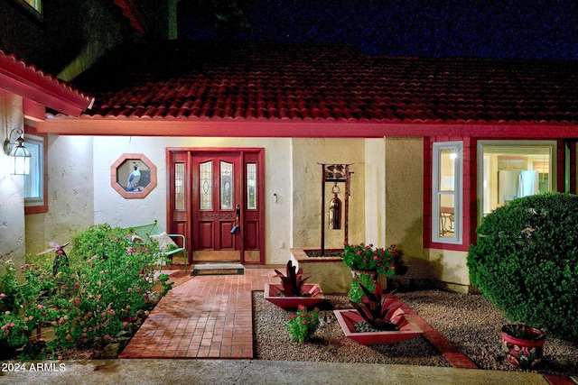 view of exterior entry at twilight