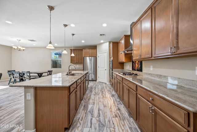 1344 N Claiborne, Mesa, AZ 85205 - kitchen featuring appliances with stainless steel finishes, a sink, light wood-type flooring, brown cabinets, and recessed lighting