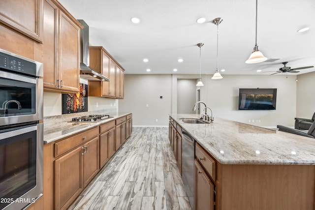 1344 N Claiborne, Mesa, AZ 85205 - kitchen with a sink, stainless steel appliances, wall chimney range hood, a center island with sink, and brown cabinets