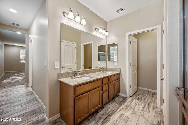 1344 N Claiborne, Mesa, AZ 85205 - bathroom with double vanity, wood finished floors, and baseboards