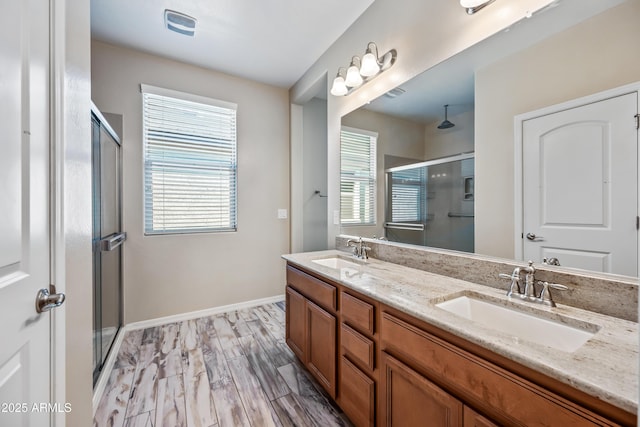 1344 N Claiborne, Mesa, AZ 85205 - bathroom featuring a stall shower, double vanity, and baseboards