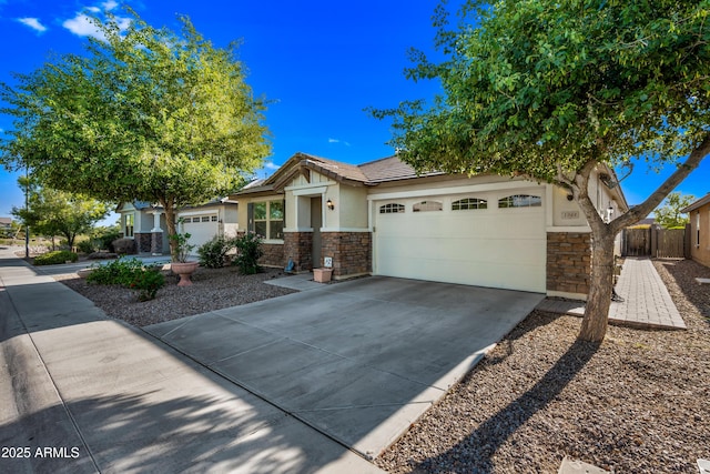 1344 N Claiborne, Mesa, AZ 85205 - view of front of home with stone siding, a garage, stucco siding, driveway, and a tiled roof
