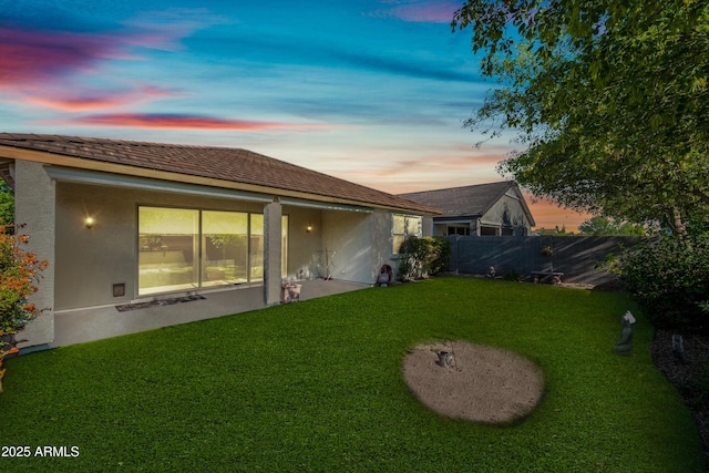 1344 N Claiborne, Mesa, AZ 85205 - back of house at dusk featuring stucco siding and a patio