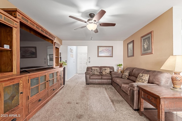 carpeted living room with ceiling fan