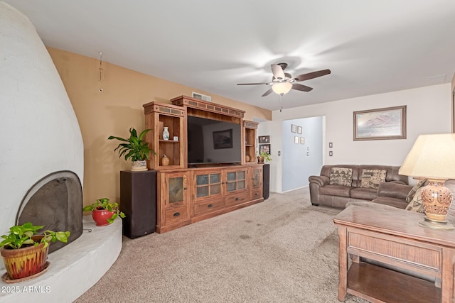 living room with ceiling fan and carpet