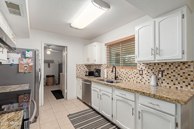 kitchen with white cabinets, stainless steel appliances, sink, and ceiling fan