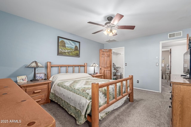 bedroom featuring dark carpet, a closet, ceiling fan, and a spacious closet