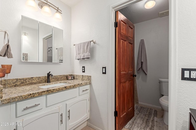 bathroom featuring toilet, wood-type flooring, and vanity