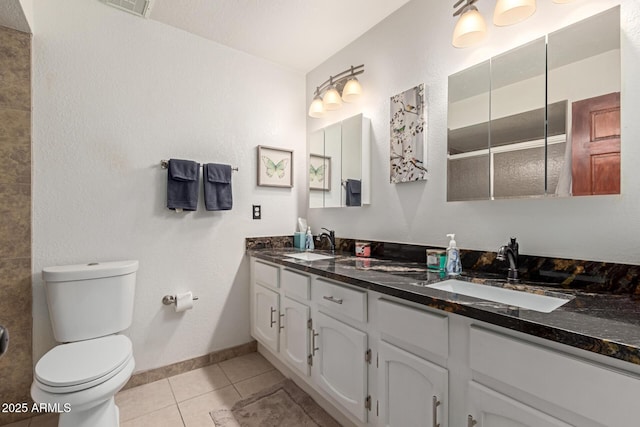 bathroom with toilet, tile patterned floors, walk in shower, and vanity