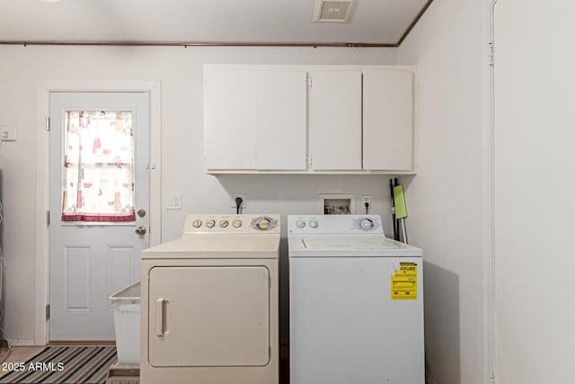 washroom with separate washer and dryer and cabinets