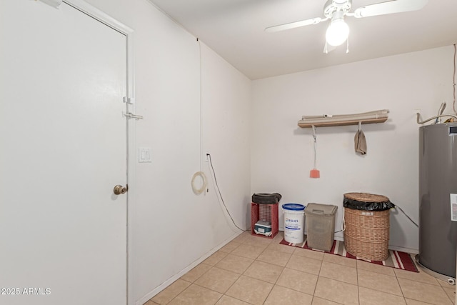 laundry room with gas water heater, ceiling fan, and light tile patterned floors