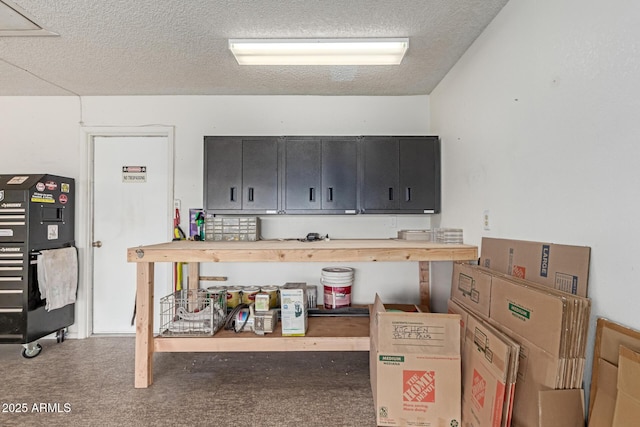 kitchen with a textured ceiling and butcher block countertops