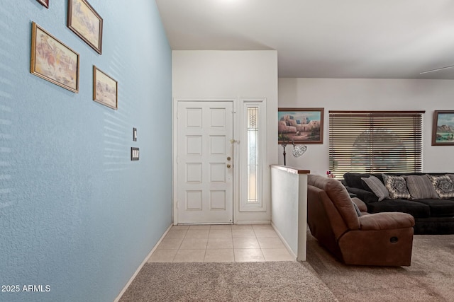 foyer entrance featuring light tile patterned flooring