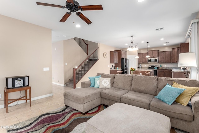 living area featuring stairs, light tile patterned flooring, recessed lighting, and visible vents