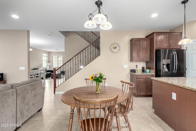 dining area with an inviting chandelier, stairway, light tile patterned floors, and recessed lighting