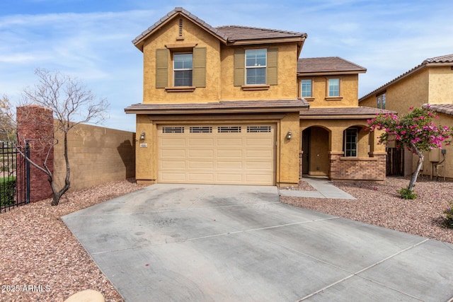 traditional-style house with fence, covered porch, stucco siding, a garage, and driveway