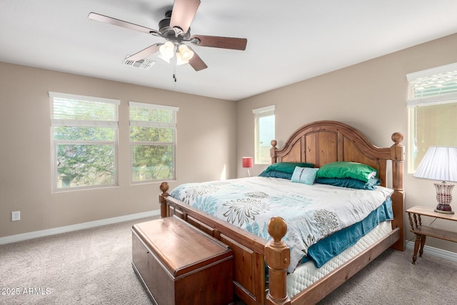 carpeted bedroom with visible vents, baseboards, and ceiling fan