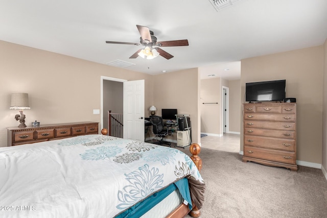 carpeted bedroom with visible vents, baseboards, and a ceiling fan